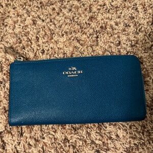 Turquoise coach long zip around wallet.